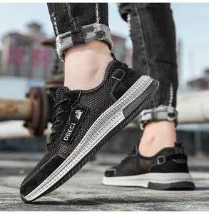 Detail of men's black leather sneakers featuring breathable mesh and thick rubber soles