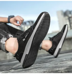 Dynamic low-angle shot of the anti-slip rubber sole and breathable mesh on casual men sneakers