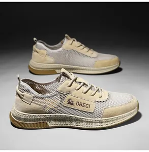 Close-up of men's breathable beige mesh sneakers with premium suede overlays and thick soles