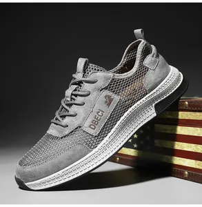 Detail view of breathable mesh and grey leather sneakers leaning against a vintage chest