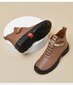 Detail of kids brown leather martin boots with velcro closure and non-slip rubber sole