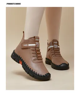 Detail of brown faux leather high-top boots featuring velcro straps and rubber soles