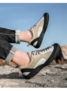Breathable beige suede outdoor hiking shoe for men shown on rocky mountain terrain