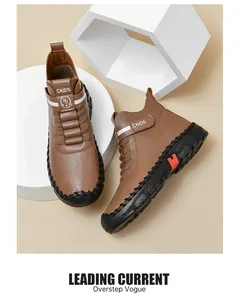 Detail of brown leather boots with black stitching and thick rubber soles for children
