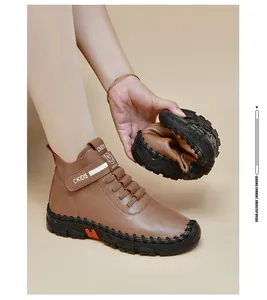 Detail showing the flexible black rubber sole of a brown leather ankle boot being bent