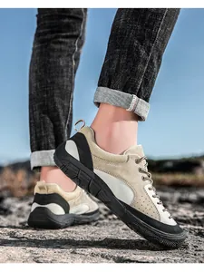 Outdoor detail of khaki suede hiking shoe on rocks with breathable mesh and rubber sole