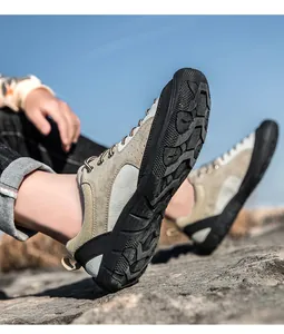Low-angle shot of rugged anti-slip rubber outsole for hiking shoes on rocky ground