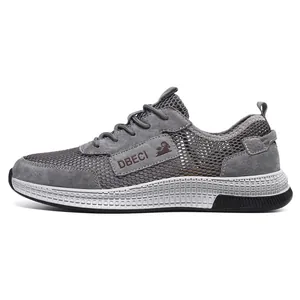 Detail of breathable grey mesh upper and matte leather panel on outdoor casual sneaker