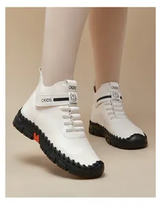 Detail of white pebbled leather high-top shoes with velcro straps and orange accents