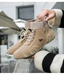 Nahaufnahme khakifarbener Outdoor-Sneaker mit Strickkragen und Ziegen-Logo-Detail