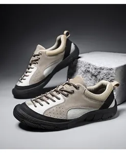 Detail of hiking shoes with suede and mesh panels showing rubber toe reinforcement