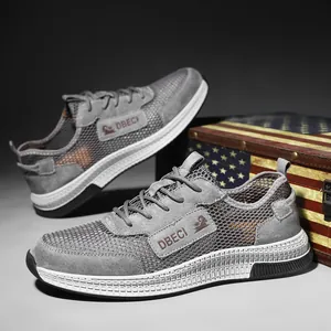 Men's grey leather mesh casual shoes with DBECI logo on vintage wooden chest