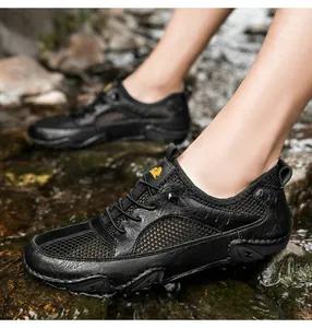 Close-up of men's leather hiking sandal with breathable mesh in a flowing stream