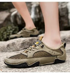 Close-up of khaki breathable mesh sneaker with leather details on outdoor rocky terrain
