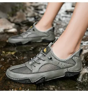 Macro detail of breathable gray leather and mesh stitching on outdoor sports sneaker