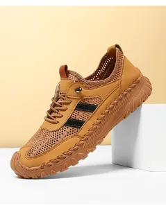 Detailweergave van camel mesh sneakers met opvallende handgemaakte contraststiksels aan de zijkant