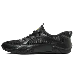 Detail view of breathable black mesh and premium leather panels on men's casual sneakers