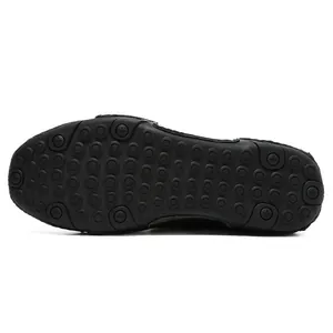 Detail of black non-slip rubber sole with dense circular grip patterns for men shoe