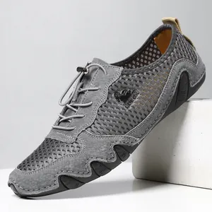 Grijze herensneakers van ademend mesh met leren panelen en golvende rubberen zolen