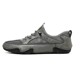 Detail of grey leather and breathable mesh upper with quick-lace system on men's sport shoe