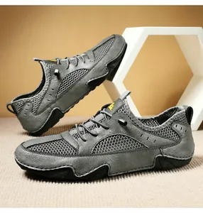 Detail of grey leather mesh outdoor shoes with quick lace system and rubber toe cap