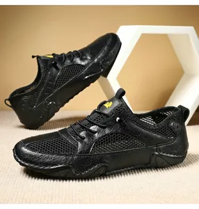 Detail view of black breathable mesh and leather sneakers with durable rubber outsoles