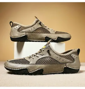 Detail view of breathable mesh and genuine leather stitching on outdoor men's sneakers