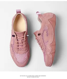 Detail of pink mesh sneaker with suede panels and micro tag showing breathable texture