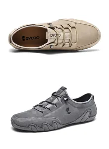 Detail view of leather casual shoes in tan and grey with elastic laces and logo