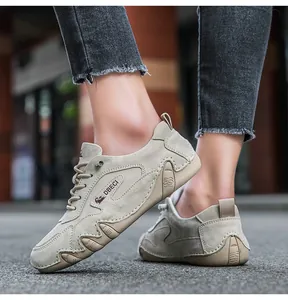 Close-up of khaki suede outdoor sneakers showing DBECI logo and rubber sole detail