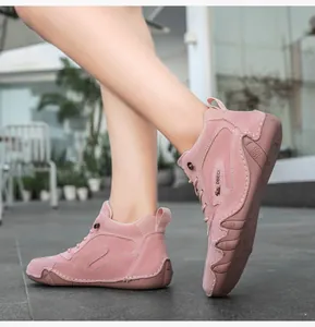 Dynamic side view of pink genuine leather high-top sneakers with durable non-slip soles
