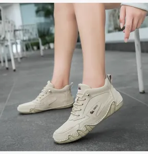 Detailed close-up of premium beige suede leather high-top shoe with durable rubber sole
