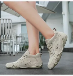 Detail view of leather high-top boots with anti-slip rubber soles and stitched patterns