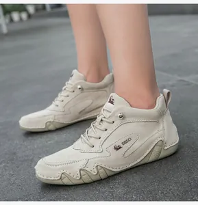 Detailed macro view of the premium beige suede texture and DBECI logo on the stylish boot