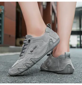 Detailed view of gray suede outdoor casual sneakers with handcrafted stitching and rubber soles