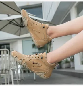 Detail view of khaki leather high-top boot featuring DBECI logo and non-slip rubber sole