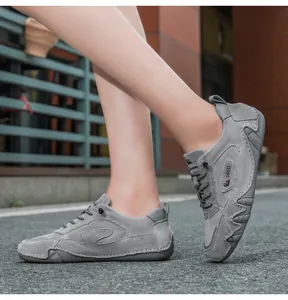 Detail of dark grey suede leather casual shoes with handcrafted stitching and non-slip sole