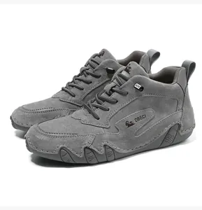 Detail of grey nubuck leather high-top sneakers with durable wavy rubber soles