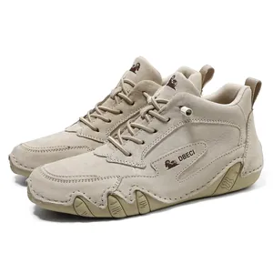 Detailed view of beige suede high-top leather boots featuring side logo and non-slip sole