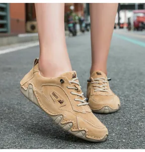 On-foot shot of khaki suede outdoor casual shoes with DBECI logo and stitching details