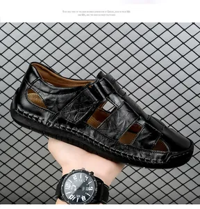 Macro shot of men's black leather sandals featuring detailed stitching and breathable cut-outs