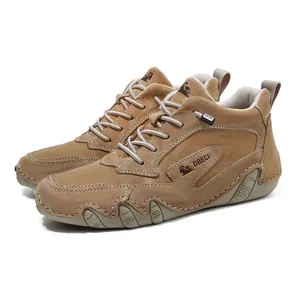 Close-up of tan leather high-top boots featuring white stitching and ripple rubber soles