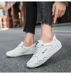 Detailed side view of white leather leisure shoes with wave stitching and DBECI branding