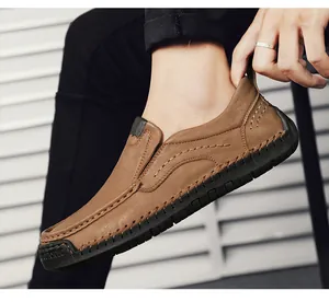 Macro shot of durable hand-stitched leather detail on brown slip-on casual men shoes