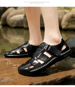 Detail of black leather outdoor sandals featuring breathable cut-outs and stitching