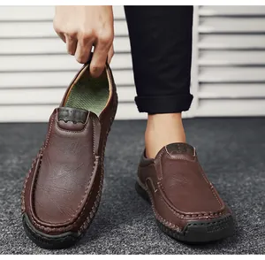 Detail of hand-stitched seams and textured brown leather on men's outdoor casual loafers