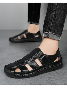 Detailed shot of men's black leather sandals featuring handcrafted stitching and rubber soles