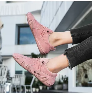Detail of pink suede leisure sneaker showing white stitching and wave-patterned rubber sole