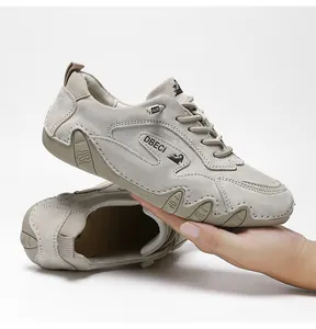 Detail of nubuck leather texture and durable rubber sole on grey outdoor leisure shoe