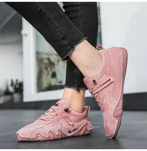 Close-up of pink suede casual sneaker featuring DBECI branding and wavy rubber sole